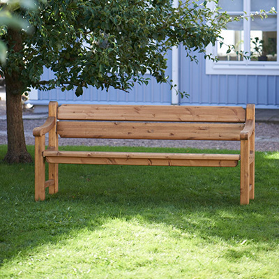 All wood bench, very traditional with arm and backrest.
